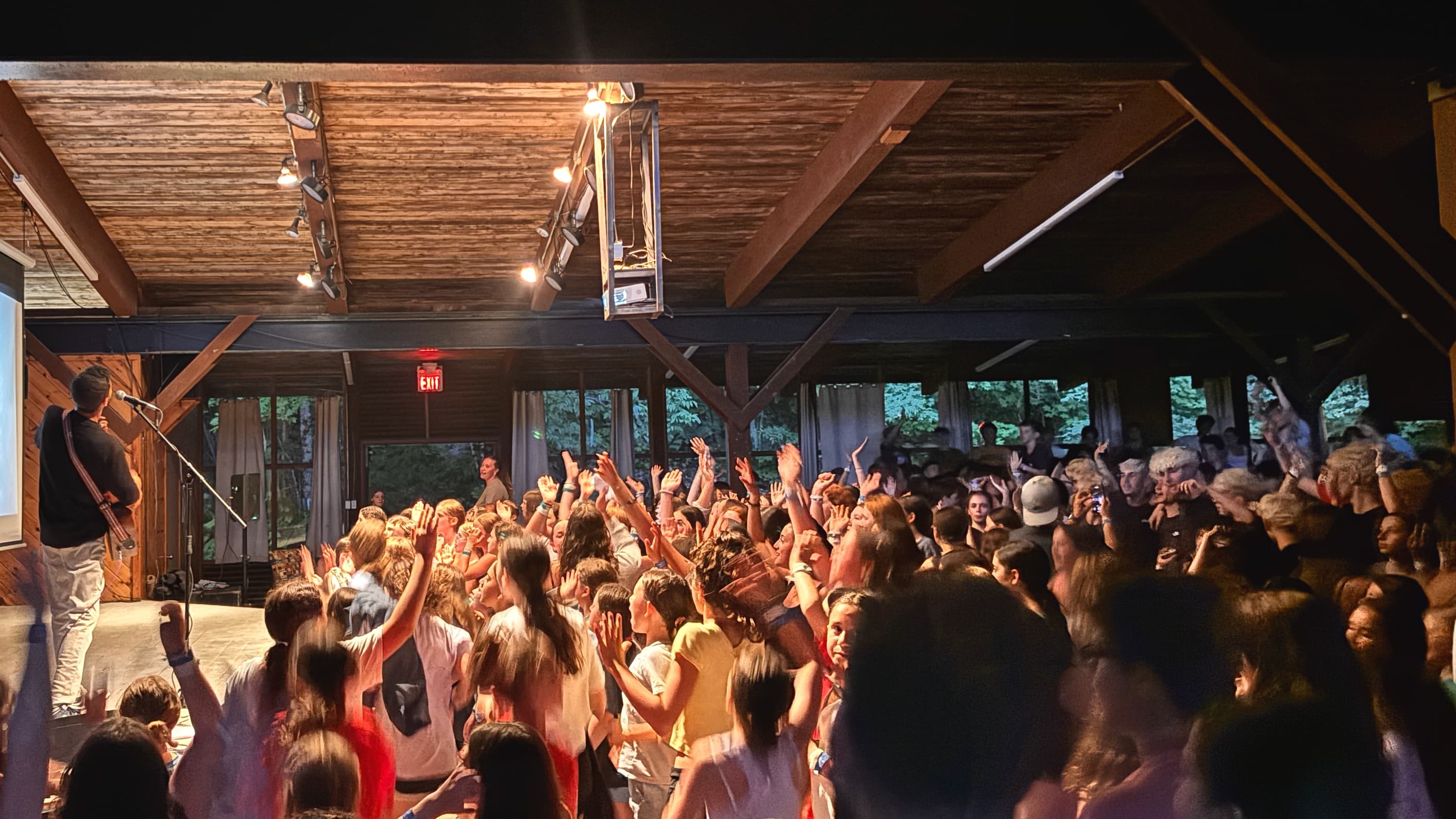 Barak leading a high-energy song session with a crowd