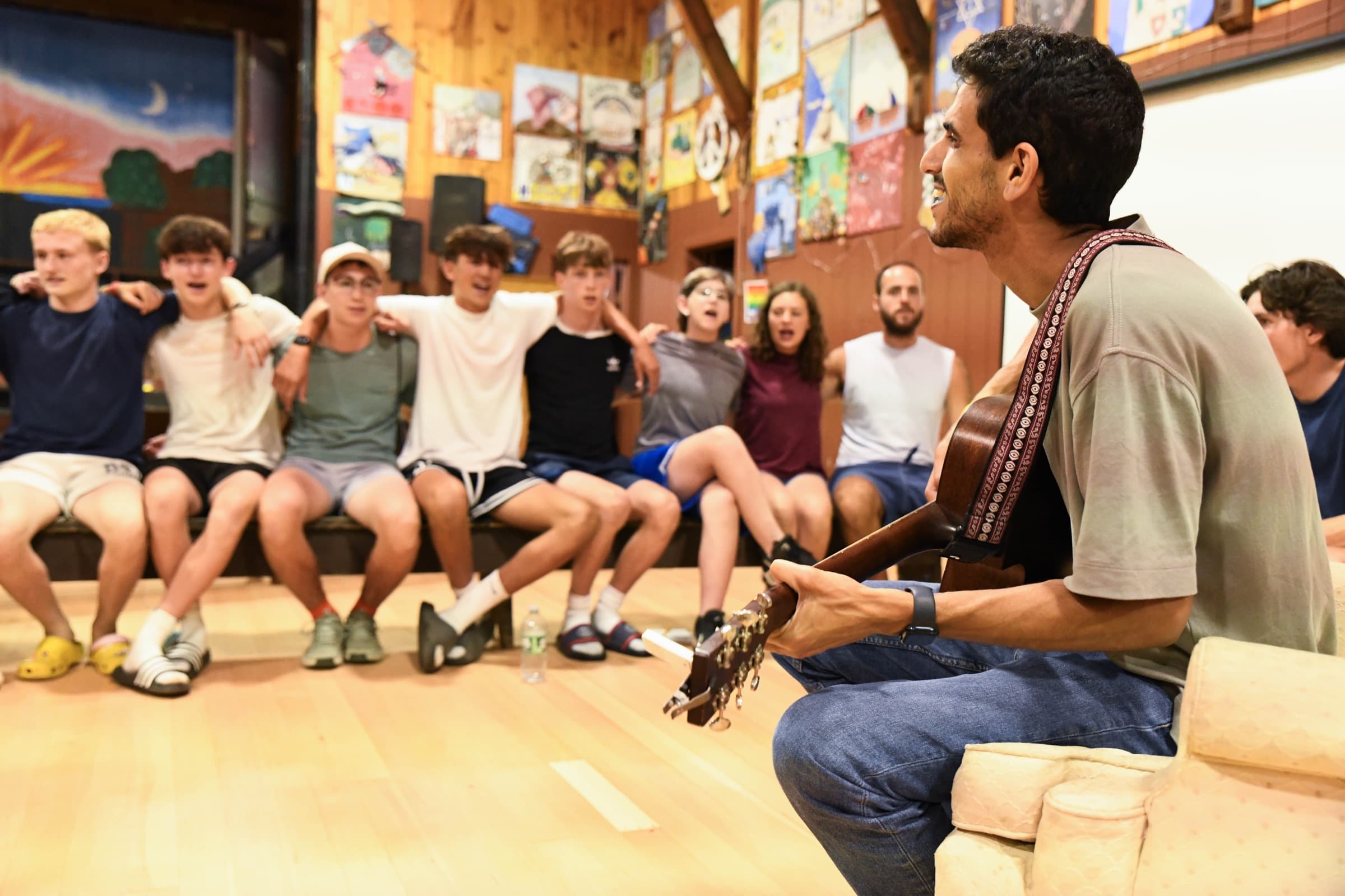 Barak leading a warm singalong with guitar